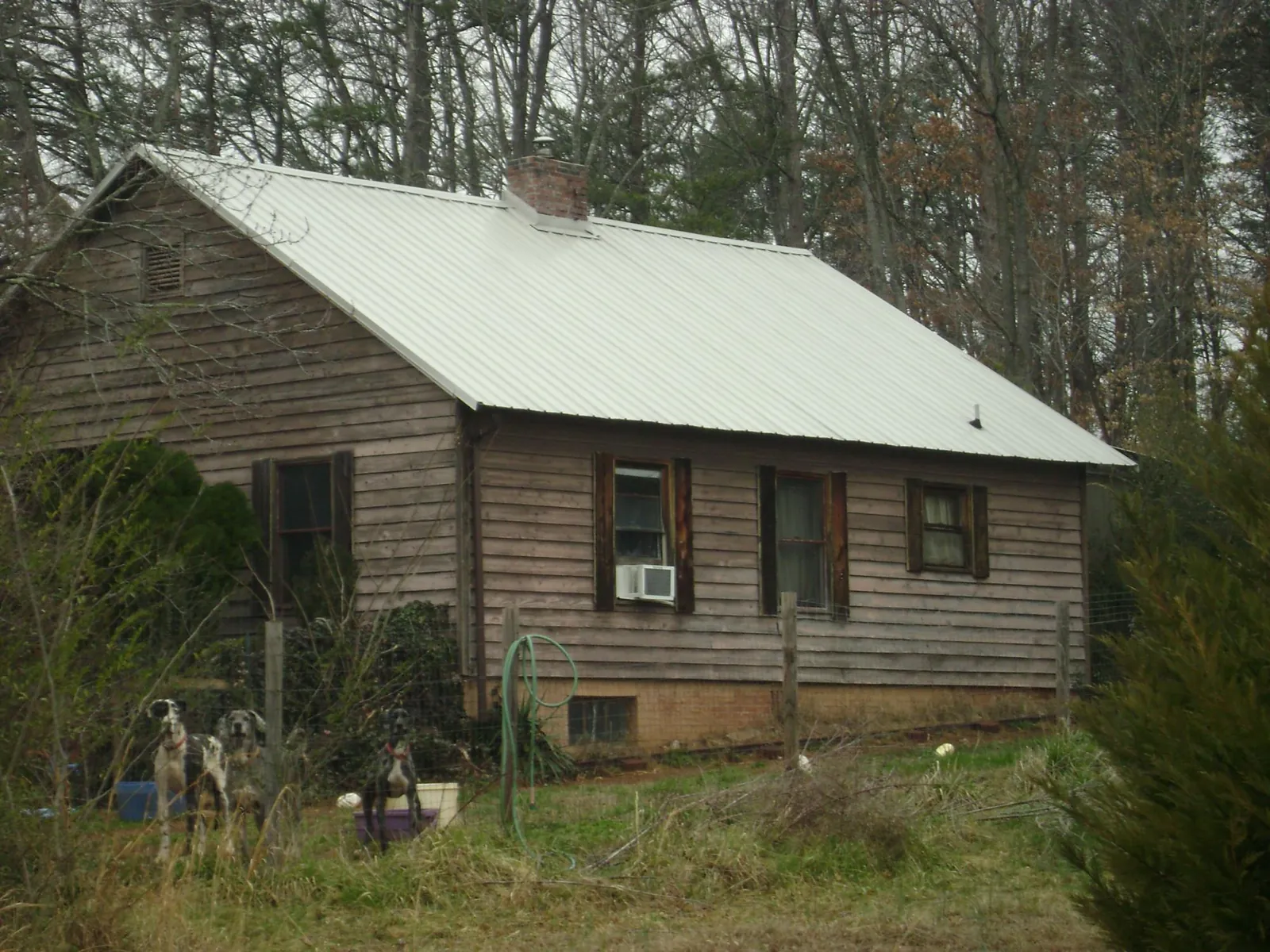 White metal roof on an old wood sided farmhouse, from a Metal Roof Installation job in Lake Pleasant